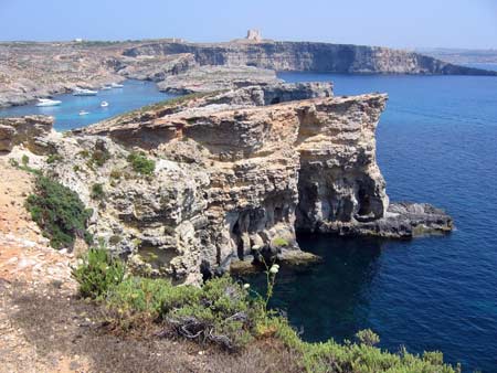 Comino in between Malta and Gozo with limestone cliffs and Blue Lagoon